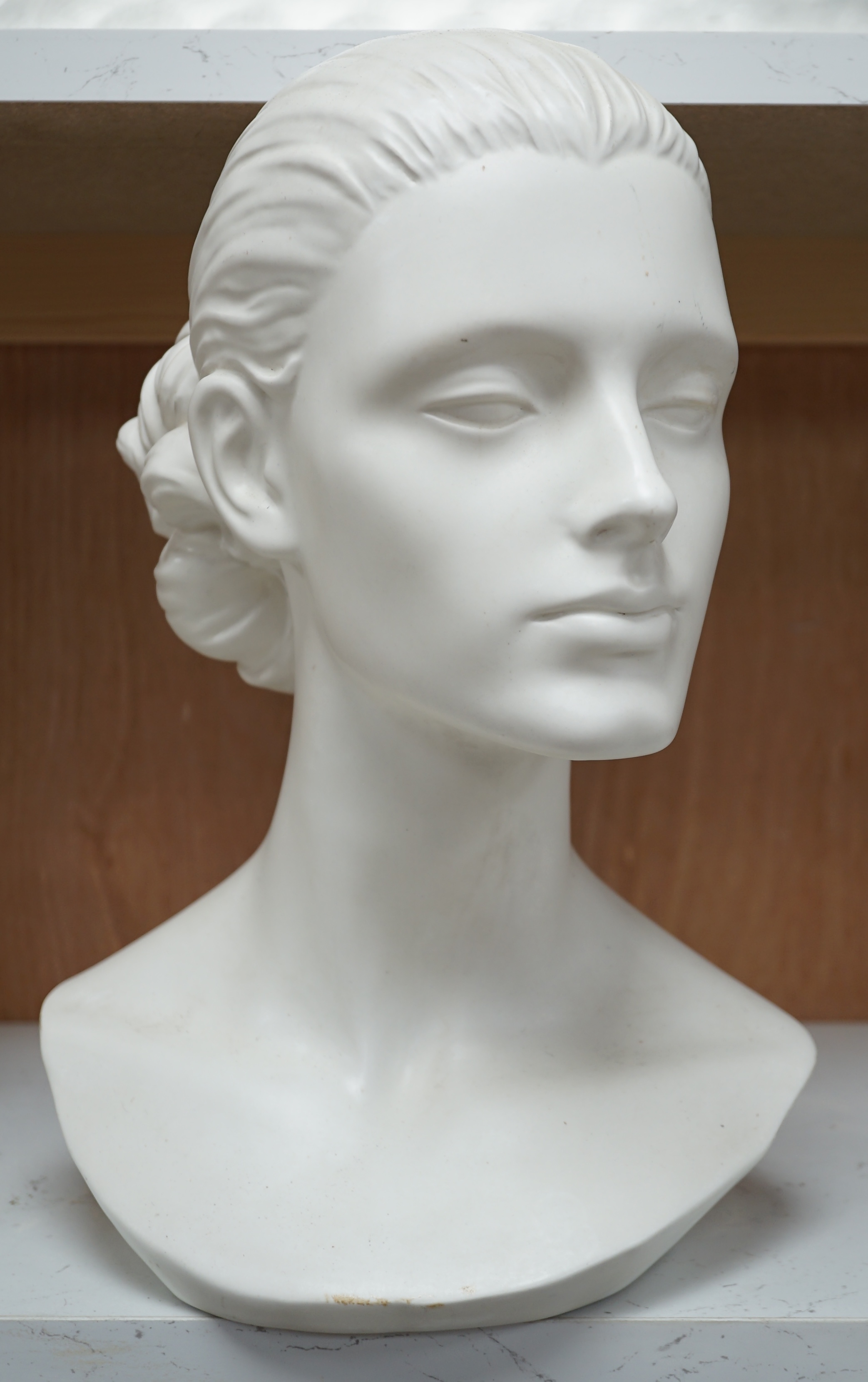 A Mouska white ceramic bust of a young woman, 33cm high. Condition - various chips to glazing on base